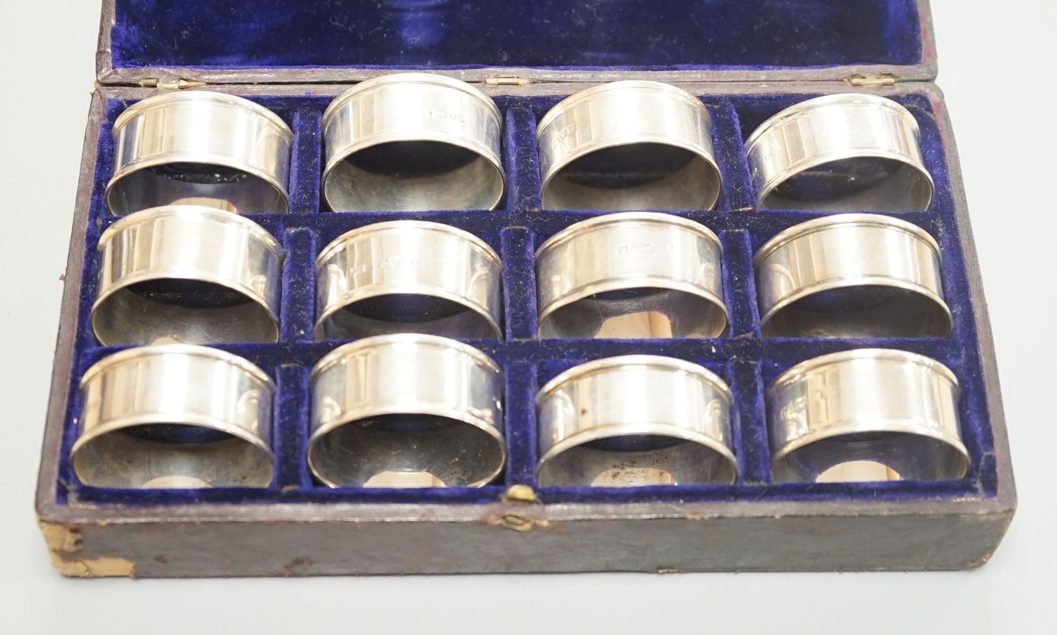 A cased matched set of twelve silver napkin rings by Charles Horner, Chester, various dates.